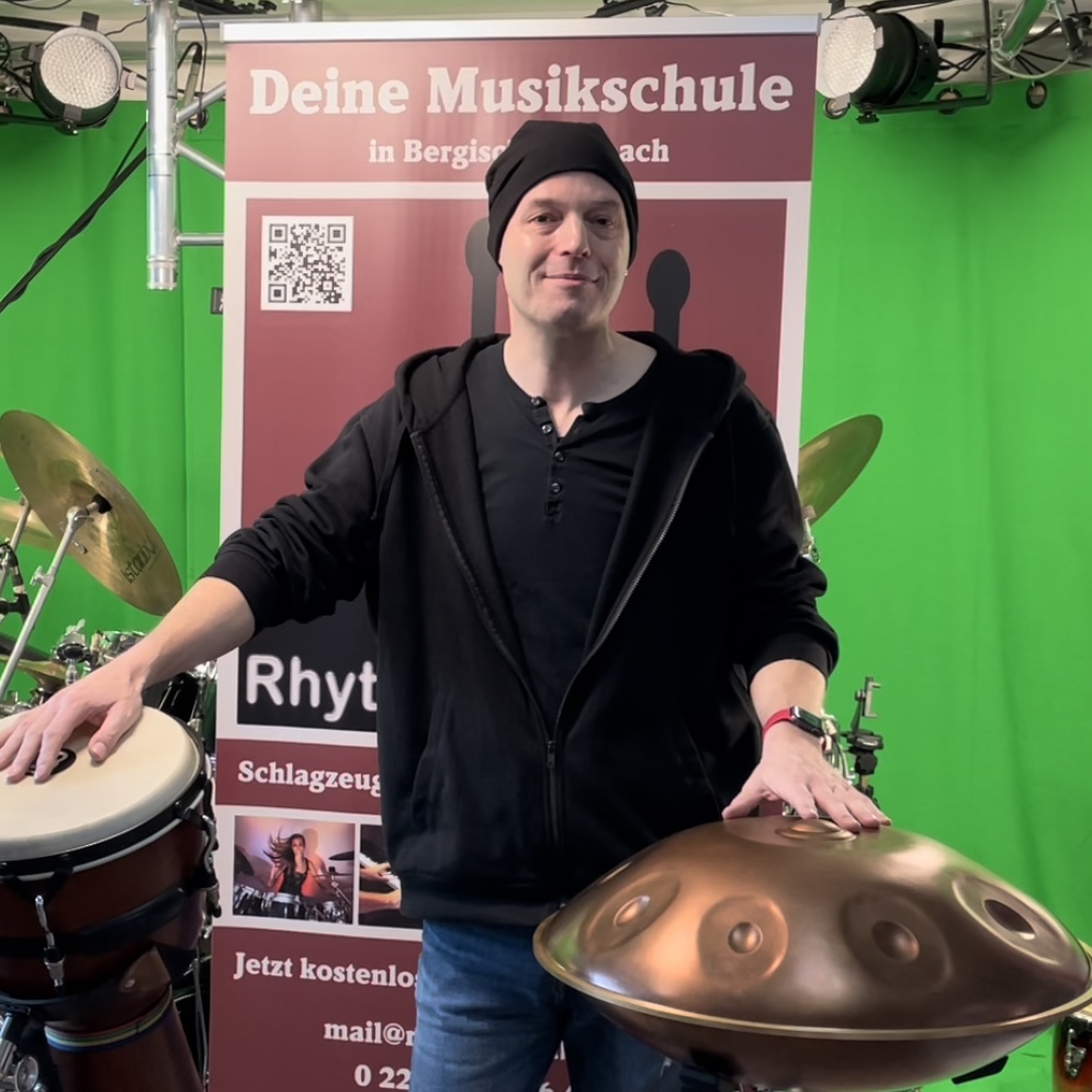 Auf diesem Bild ist eine Handpan, eine Djembe und ein Cajon und ein Mann zu sehen